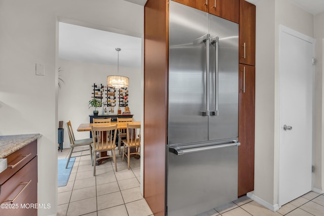 45 Victory Ct, Old Bridge, NJ 08857 - kitchen featuring built in fridge, light tile patterned floors, brown cabinetry, light stone countertops, and a chandelier