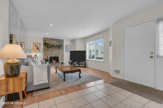 45 Victory Ct, Old Bridge, NJ 08857 - tiled living room featuring a brick fireplace and recessed lighting