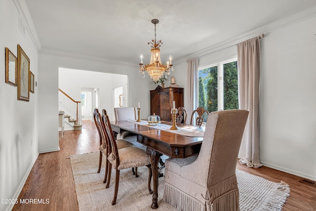 3058 Governors Xing, Wall, NJ 07719 - dining room with a chandelier, plenty of natural light, stairway, crown molding, and wood finished floors