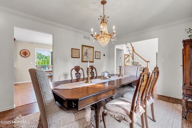 3058 Governors Xing, Wall, NJ 07719 - dining room featuring a chandelier, ornamental molding, stairway, and wood finished floors
