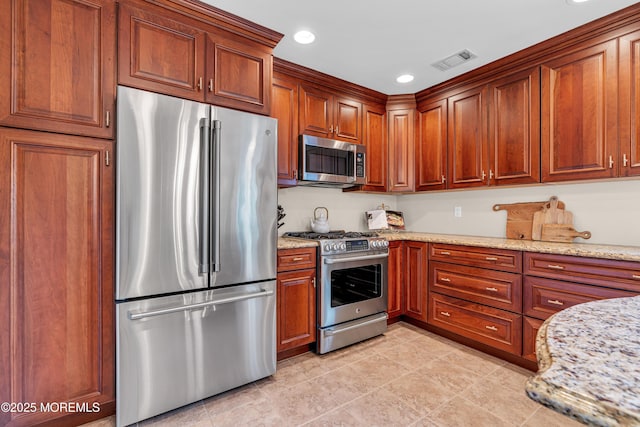 3058 Governors Xing, Wall, NJ 07719 - kitchen with stainless steel appliances, light stone counters, recessed lighting, brown cabinets, and light tile patterned floors