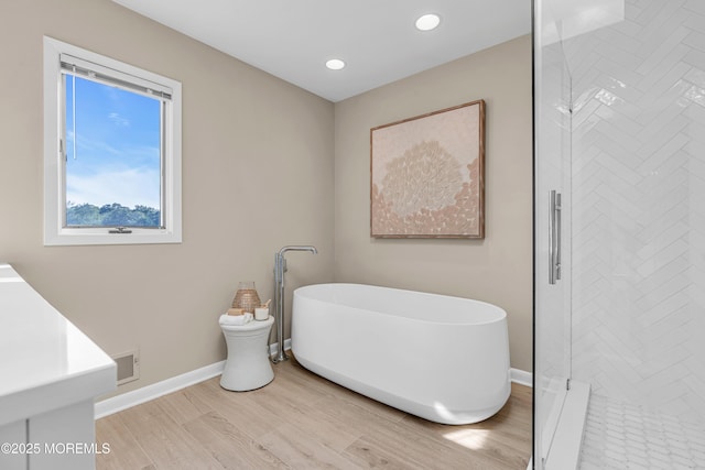 3058 Governors Xing, Wall, NJ 07719 - bathroom with a freestanding tub, wood finished floors, a stall shower, and recessed lighting