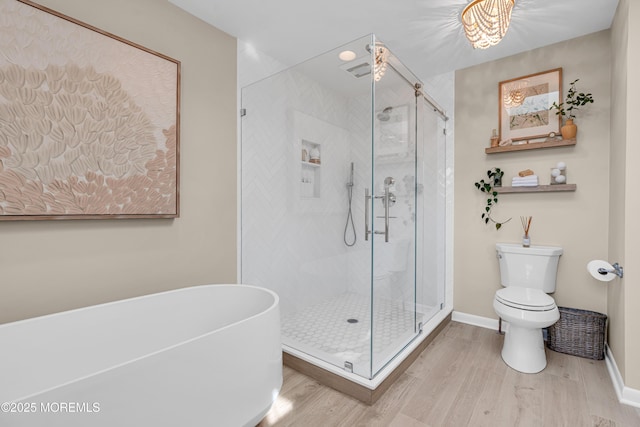 3058 Governors Xing, Wall, NJ 07719 - bathroom featuring wood finished floors, a freestanding bath, and a shower stall