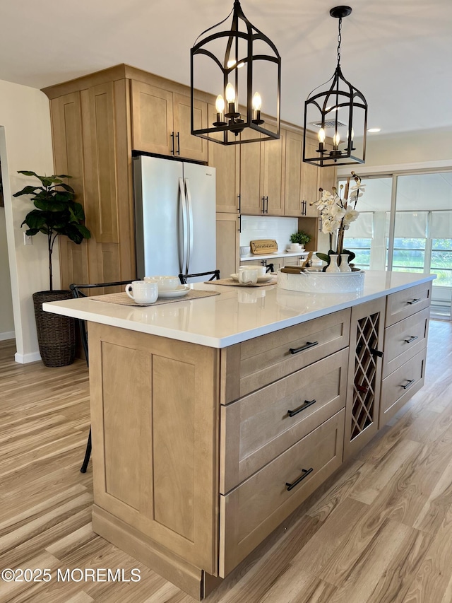 31 Guadeloupe Dr, Toms River, NJ 08757 - kitchen featuring freestanding refrigerator, light wood-style floors, a kitchen island, light countertops, and a chandelier