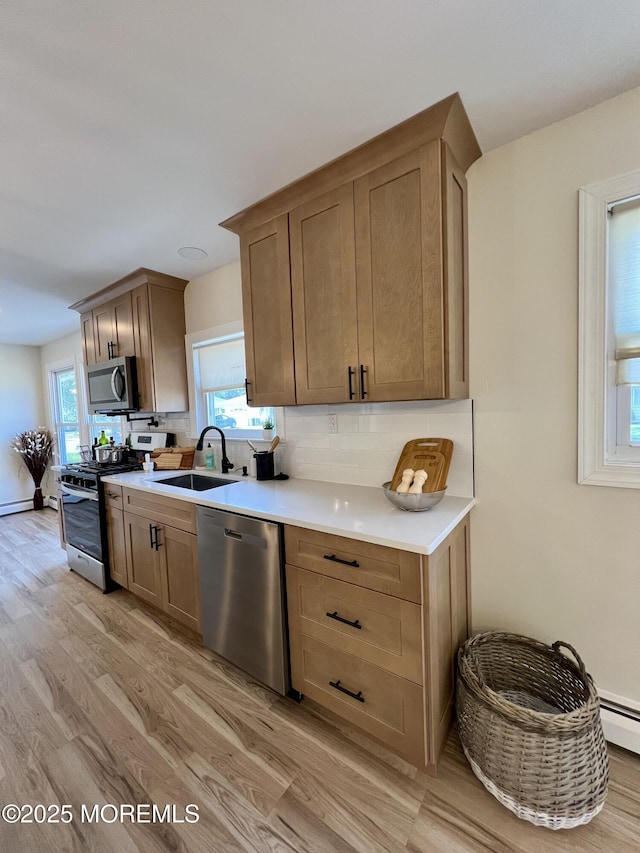 31 Guadeloupe Dr, Toms River, NJ 08757 - kitchen with appliances with stainless steel finishes, light wood-style flooring, decorative backsplash, and healthy amount of natural light