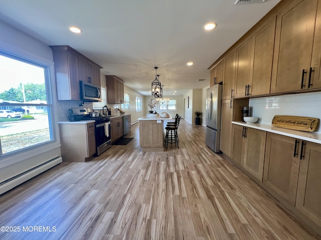 31 Guadeloupe Dr, Toms River, NJ 08757 - kitchen with stainless steel appliances, a chandelier, a kitchen bar, light countertops, and recessed lighting
