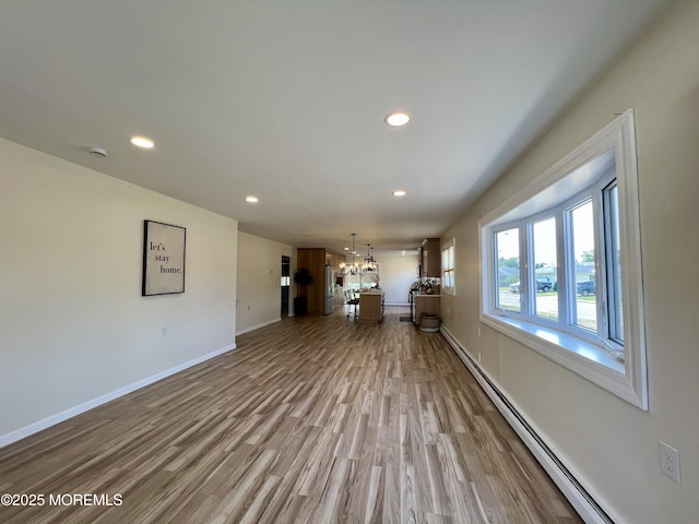 31 Guadeloupe Dr, Toms River, NJ 08757 - unfurnished living room with a baseboard heating unit, a chandelier, light wood-type flooring, and recessed lighting