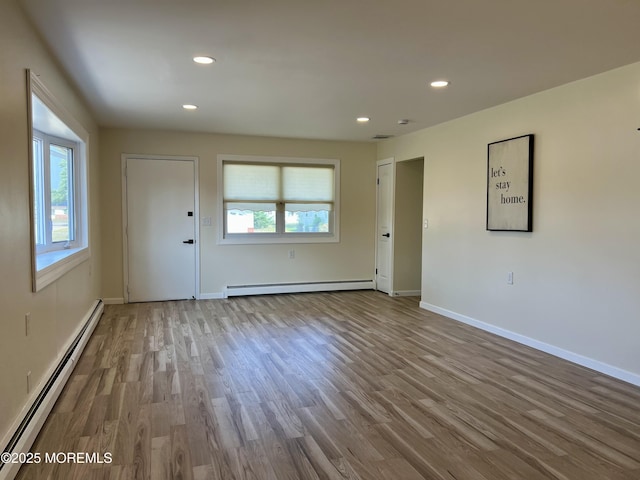 31 Guadeloupe Dr, Toms River, NJ 08757 - unfurnished living room with a baseboard heating unit, wood finished floors, and recessed lighting