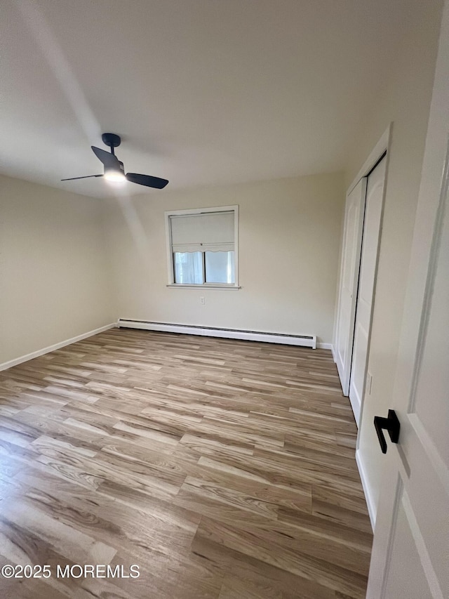 31 Guadeloupe Dr, Toms River, NJ 08757 - unfurnished bedroom featuring a baseboard radiator, wood finished floors, a closet, and a ceiling fan
