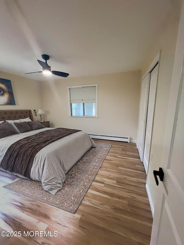31 Guadeloupe Dr, Toms River, NJ 08757 - bedroom featuring a baseboard radiator, wood finished floors, a closet, and a ceiling fan