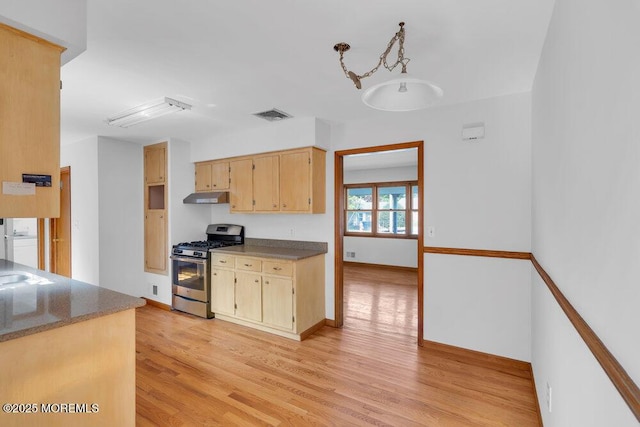 1131 Canal Dr, Point Pleasant, NJ 08742 - kitchen featuring stainless steel gas range, under cabinet range hood, light wood-type flooring, and dark countertops
