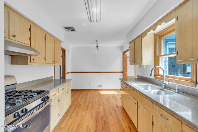 1131 Canal Dr, Point Pleasant, NJ 08742 - kitchen with gas stove, under cabinet range hood, light wood-style floors, and light brown cabinetry