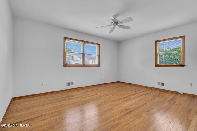 1131 Canal Dr, Point Pleasant, NJ 08742 - empty room with healthy amount of natural light, light wood-style floors, and a ceiling fan