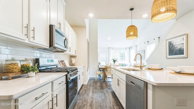 10 Victoria Gardens Sq, Neptune Township, NJ 07753 - kitchen with stainless steel appliances, dark wood-type flooring, light countertops, tasteful backsplash, and white cabinetry