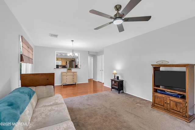 65 Sycamore Rd, Manahawkin, NJ 08050 - carpeted living area with a chandelier and ceiling fan