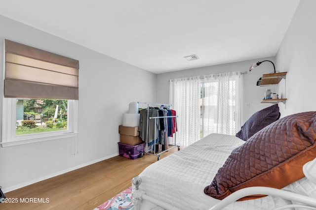 65 Sycamore Rd, Manahawkin, NJ 08050 - bedroom featuring multiple windows, wood finished floors, and access to exterior