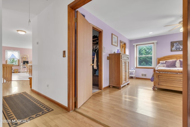 26 Shasta Ln, Toms River, NJ 08753 - bedroom featuring multiple windows, light wood-type flooring, and a walk in closet