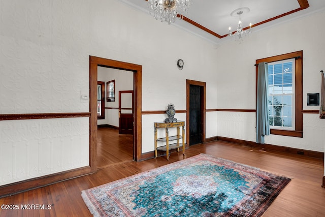 55 E Front St, Keyport, NJ 07735 - empty room featuring a chandelier, crown molding, wood finished floors, and a towering ceiling