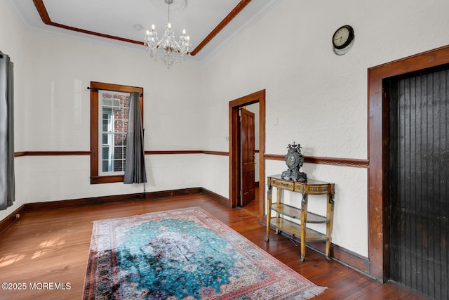55 E Front St, Keyport, NJ 07735 - empty room with ornamental molding, wood finished floors, and a chandelier