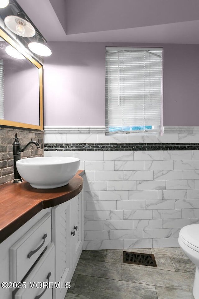 55 E Front St, Keyport, NJ 07735 - half bathroom with vanity, a wainscoted wall, tile walls, and tile patterned floors