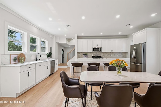 24 Tuers Pl, Upper Montclair, NJ 07043 - dining space featuring light wood-type flooring, recessed lighting, and stairway