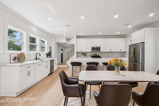 24 Tuers Pl, Upper Montclair, NJ 07043 - dining room with light wood-style flooring, recessed lighting, and stairs