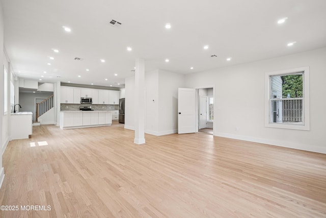 24 Tuers Pl, Upper Montclair, NJ 07043 - unfurnished living room featuring recessed lighting and light wood-type flooring