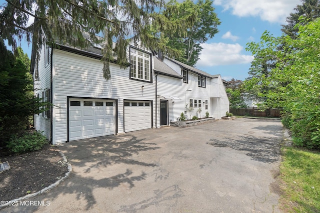 24 Tuers Pl, Upper Montclair, NJ 07043 - view of side of home with driveway and an attached garage