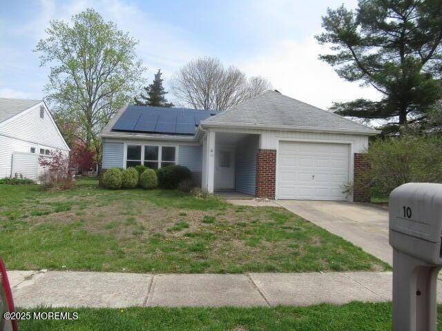 10 Dunstable Rd, Vincentown, NJ 08088 - ranch-style home featuring driveway, roof mounted solar panels, a garage, brick siding, and a front lawn