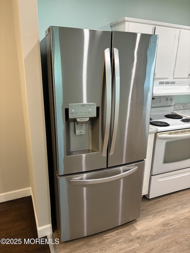 2211 Yorktowne Blvd, Toms River, NJ 08753 - kitchen with stainless steel fridge, electric range, under cabinet range hood, white cabinets, and light wood-style flooring