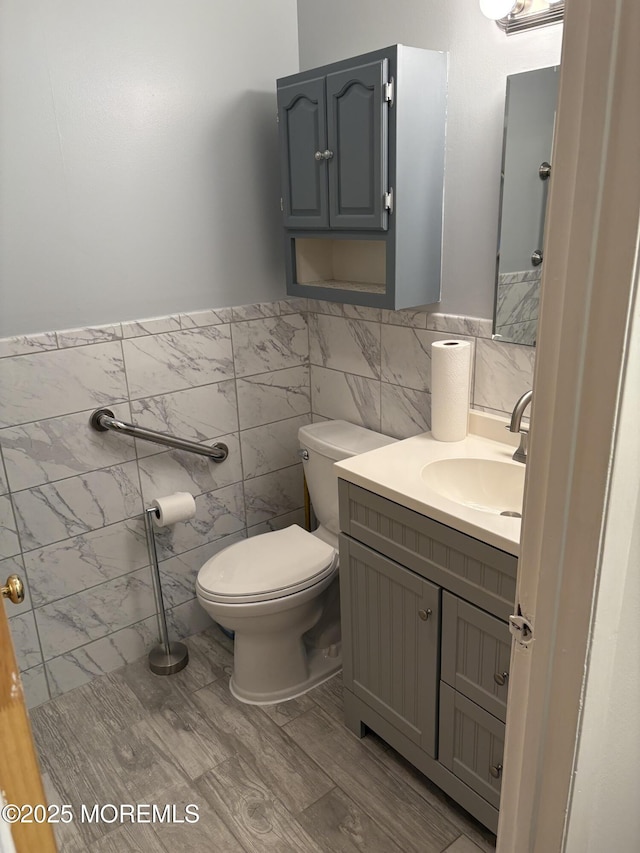 2211 Yorktowne Blvd, Toms River, NJ 08753 - bathroom with vanity, tile walls, wainscoting, and wood finished floors