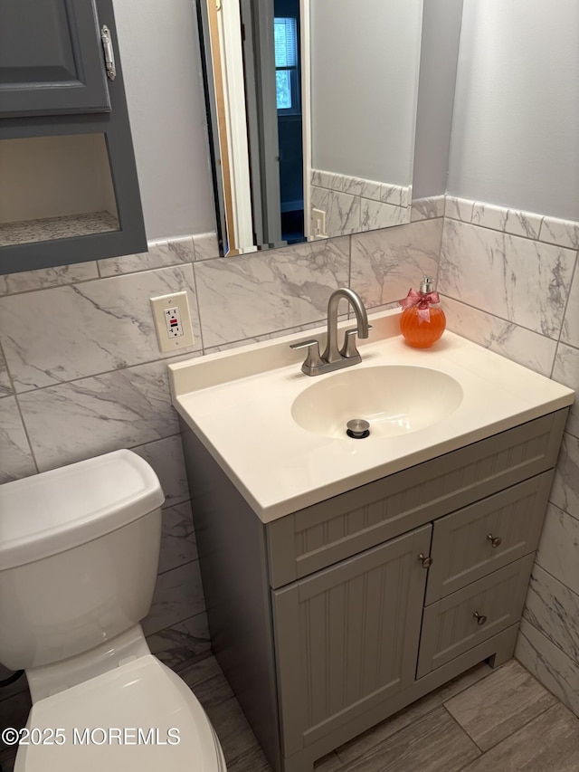 2211 Yorktowne Blvd, Toms River, NJ 08753 - half bathroom featuring vanity, tile walls, and wainscoting