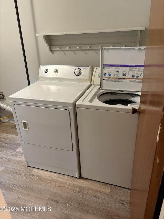 2211 Yorktowne Blvd, Toms River, NJ 08753 - laundry room with washing machine and dryer and light wood-style floors