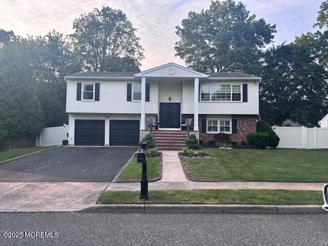 11 Bristlecone Dr, Howell, NJ 07731 - split foyer home featuring asphalt driveway and an attached garage