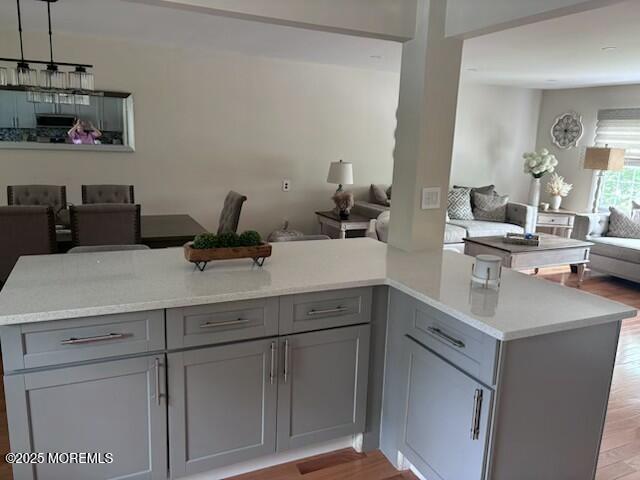 11 Bristlecone Dr, Howell, NJ 07731 - kitchen with open floor plan, gray cabinets, light wood-type flooring, and light countertops