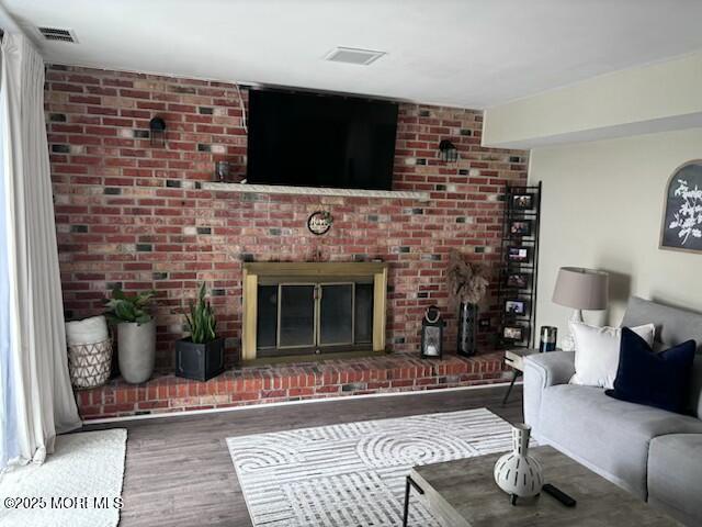 11 Bristlecone Dr, Howell, NJ 07731 - living area featuring wood finished floors and a fireplace