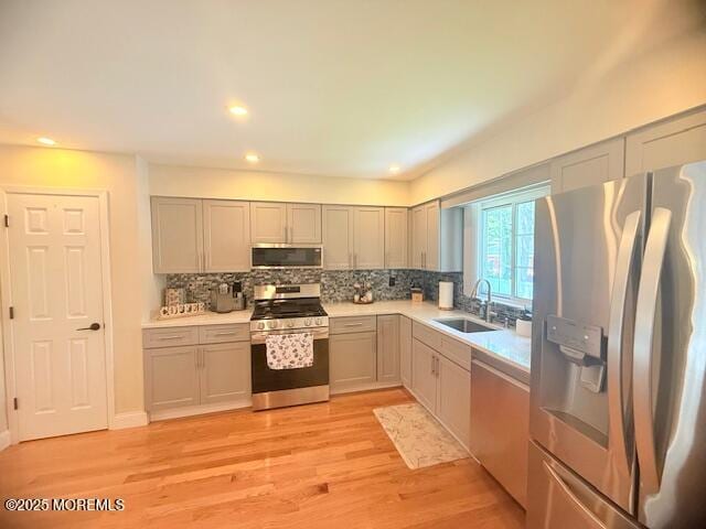 11 Bristlecone Dr, Howell, NJ 07731 - kitchen featuring stainless steel appliances, tasteful backsplash, light countertops, light wood-type flooring, and recessed lighting