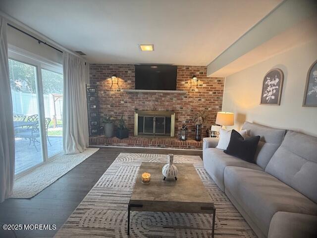 11 Bristlecone Dr, Howell, NJ 07731 - living room with a brick fireplace and wood finished floors