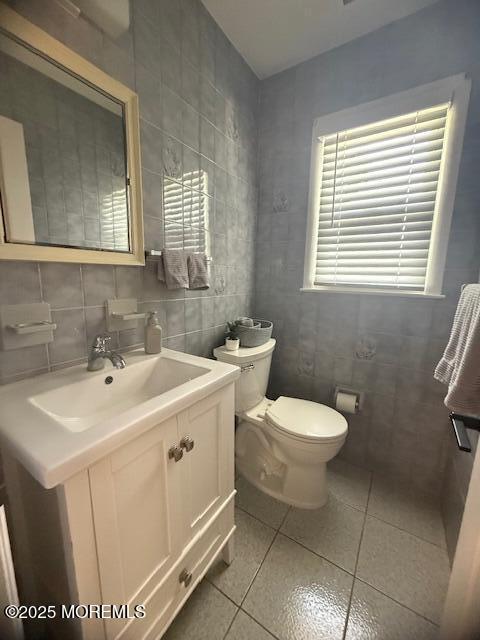 11 Bristlecone Dr, Howell, NJ 07731 - half bathroom featuring tile walls, tile patterned floors, vanity, and backsplash