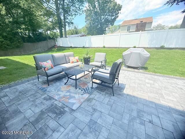 11 Bristlecone Dr, Howell, NJ 07731 - fenced backyard with an outdoor living space, a patio, and a grill