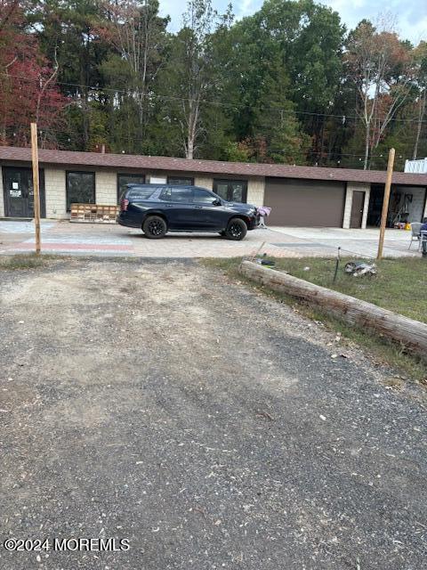 825 Rte 539, Plumsted, NJ 08533 - view of parking with an attached garage, driveway, and view of scattered trees