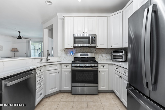 22 Cooper Ave Unit 113, Long Branch, NJ 07740 - kitchen featuring appliances with stainless steel finishes, light countertops, decorative backsplash, and white cabinetry