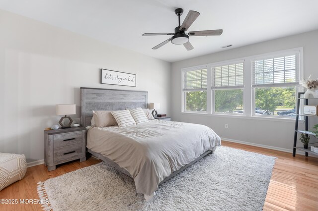 22 Cooper Ave Unit 113, Long Branch, NJ 07740 - bedroom with multiple windows, wood finished floors, and ceiling fan
