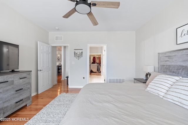 22 Cooper Ave Unit 113, Long Branch, NJ 07740 - bedroom featuring wood finished floors, a walk in closet, and a ceiling fan