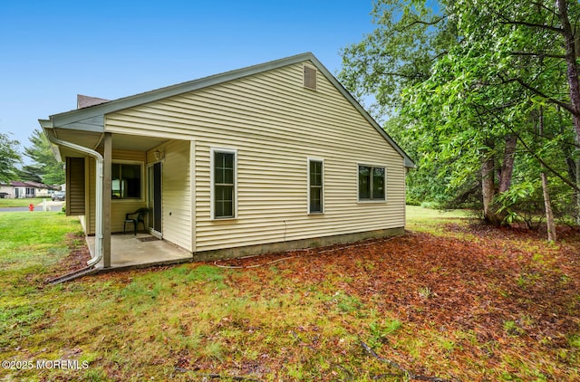 406 Betsy Ross Ln, Little Egg Harbor, NJ 08087 - rear view of house with a patio area and a yard