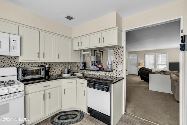 59591/2 Taylor Ave, Manasquan, NJ 08736 - kitchen featuring white appliances, white cabinets, tasteful backsplash, open floor plan, and light colored carpet