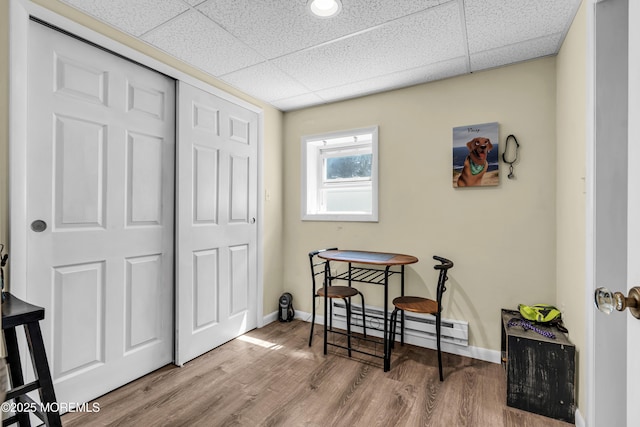 59591/2 Taylor Ave, Manasquan, NJ 08736 - dining area featuring a baseboard heating unit, a drop ceiling, and wood finished floors
