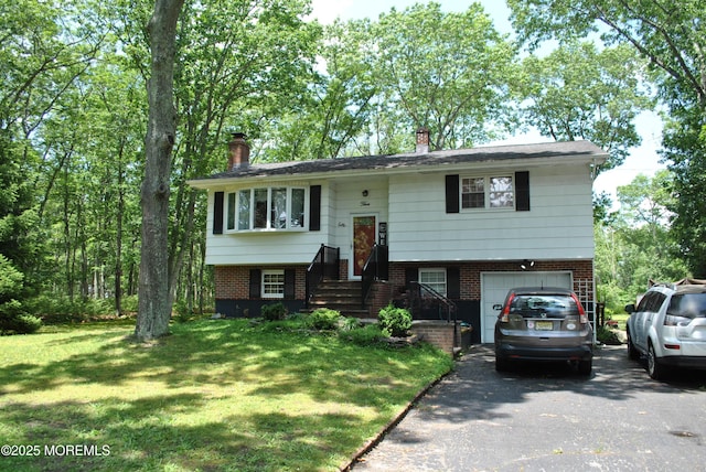 5 Poplar St, Jackson, NJ 08527 - bi-level home featuring driveway, a chimney, a garage, a front lawn, and brick siding