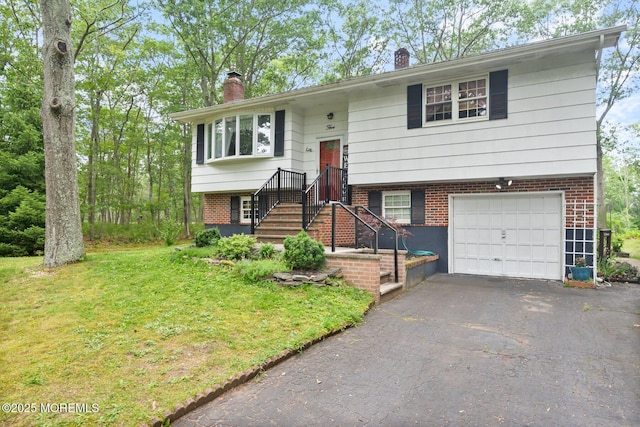 5 Poplar St, Jackson, NJ 08527 - split foyer home with a chimney, an attached garage, driveway, a front yard, and brick siding