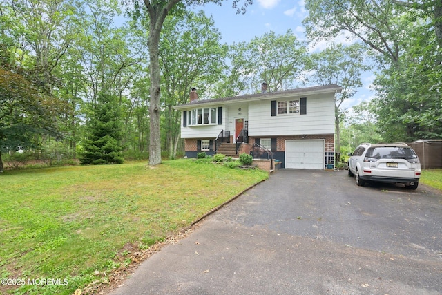 5 Poplar St, Jackson, NJ 08527 - split foyer home with brick siding, driveway, an attached garage, a front yard, and a chimney